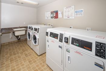 A row of washing machines in a laundromat.